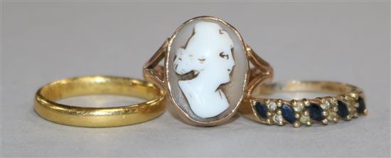 A 22ct gold wedding band, a 9ct gold cameo ring and a 9ct gold gem set ring.